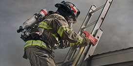 firefighter climbing a ladder of a burning house
