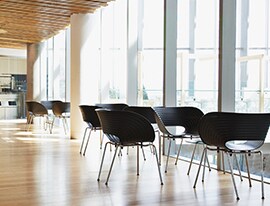 Inviting chairs sit near a sun-filled window. 3M™ Window Films increase comfort and conserve energy.