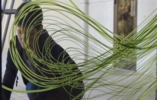 Karine Fellini, french-born artist shown creating artwork with Scotch Performance Masking tape on a window.