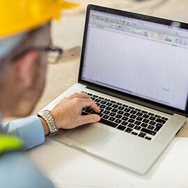 Roadway expert accessing data on a laptop from the asset management system.