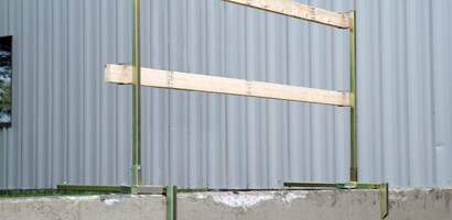 Temporary wooden guardrail attached to concrete walkway

