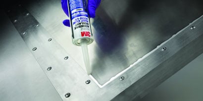 Liquid sealant being applied to metal panels to prevent water leak
