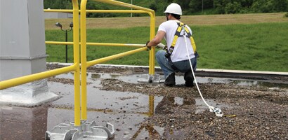 Worker setting up temporary guardrail system
