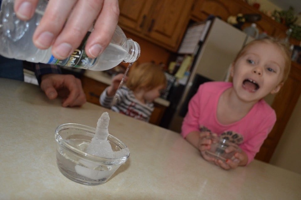 3-year-old Addison reacts with joy as her father, 3M Chemist Korey Karls, makes ice grow in their kitchen