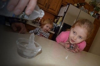 3-year-old Addison watches with curiosity joy as her father, 3M Chemist Korey Karls, demonstrates a kitchen science experiment