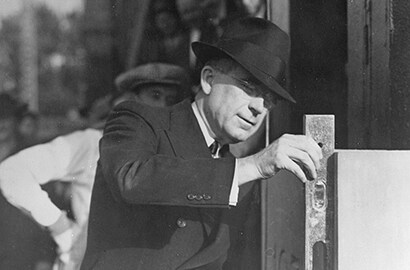 Former 3M Chairman of the Board William McKnight checking a building’s cornerstone.