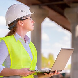 Roadway expert using a laptop on the job to access data from the asset management system.