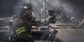Firefighter using thermal imaging camera
