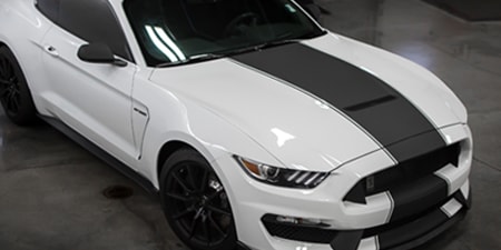 White car with black stripe accent

