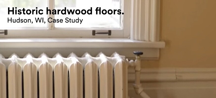 A window above an old-fashioned home radiator lets in light but rejects damaging UV rays that would damage the home’s hardwood floors.
