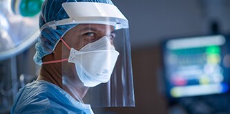Clinician wearing a filtering facepiece respirator and faceshield
