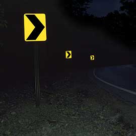 Yellow arrow signs on road corner