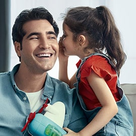 Young daughter whispering to father