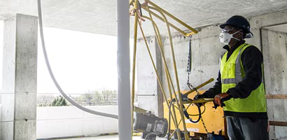Un hombre en un sitio de construcción lleva equipo de protección personal (EPP)
