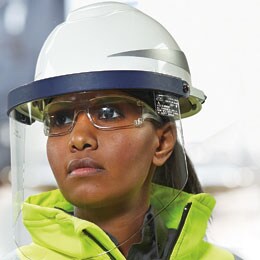 woman wearing faceshield attached to hard hat