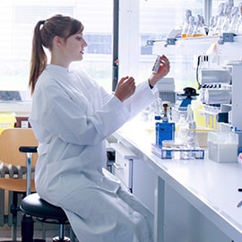 Female scientist developing a microfluidic device in a lab